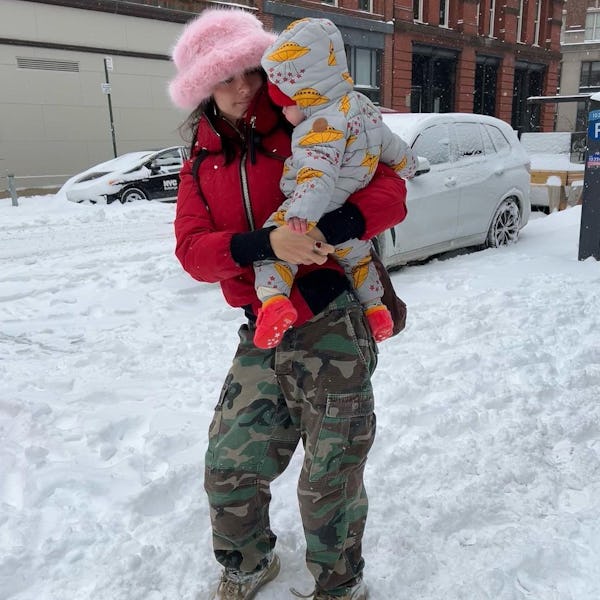 Emily Ratajkowski wears Emma Brewin pink fuzzy hat.