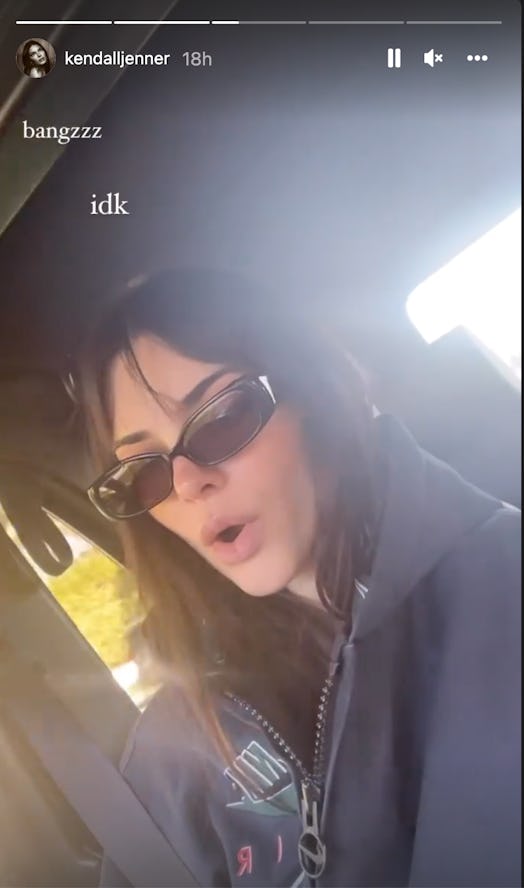 Kendall Jenner with new curtain bangs in her car on Feb. 3, 2022.