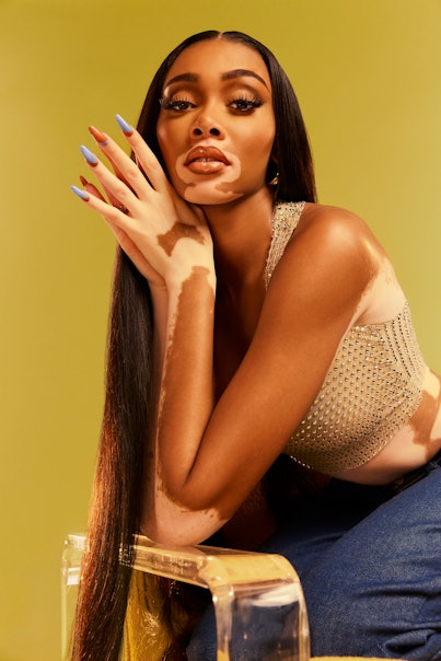 Winnie Harlow posing in a shinny top for the NYLON 's beauty article.