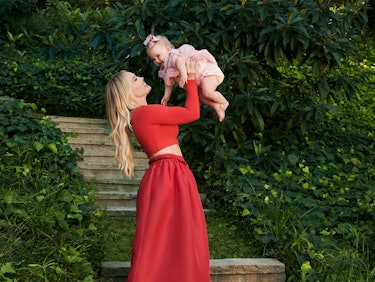 Hilary Duff lifting her daughter Mae up in the air