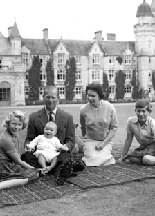 Queen Elizabeth II and her family sitting outside their Balmoral home