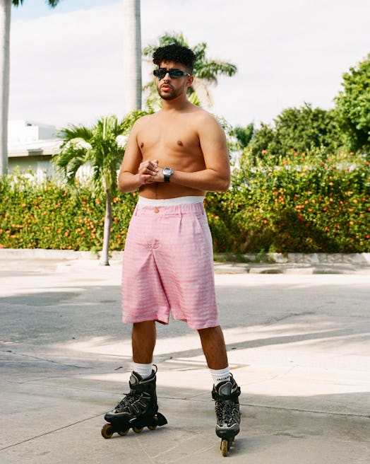 A shirtless Bad Bunny wearing rollerblades in his Jacquemus campaign