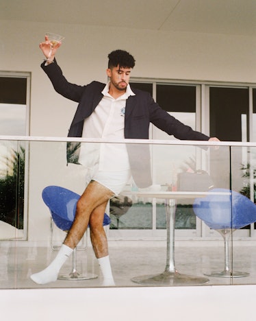 Bad Bunny holding a martini in his Jacquemus campaign