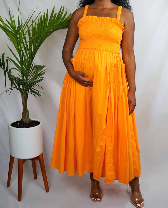 pregnant woman modeling orange dress