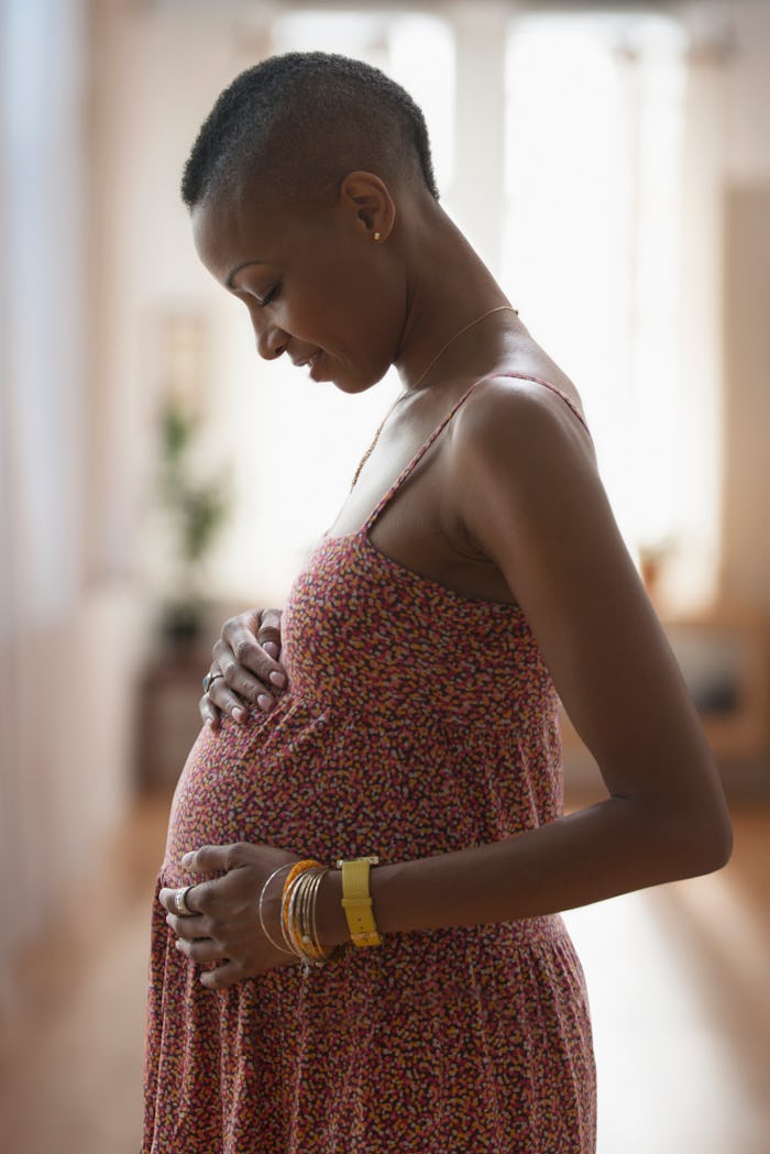 pregnant woman holding her stomach