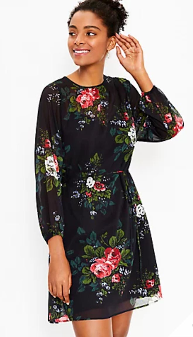 Woman modeling long sleeve dress with floral print