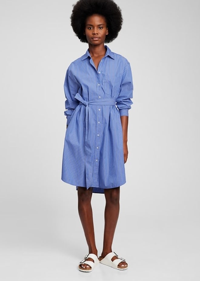 Woman modeling shirt dress; blue with white stripes