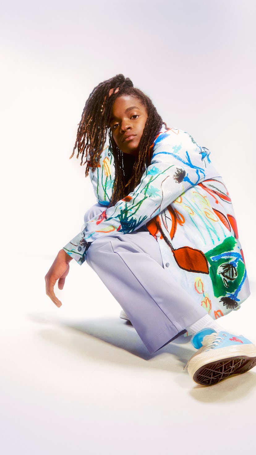 Reggae singer, songwriter, rapper, DJ and a guitarist Koffee posing in a colorful combination.