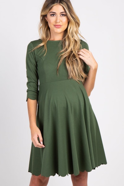 Pregnant woman modeling green dress
