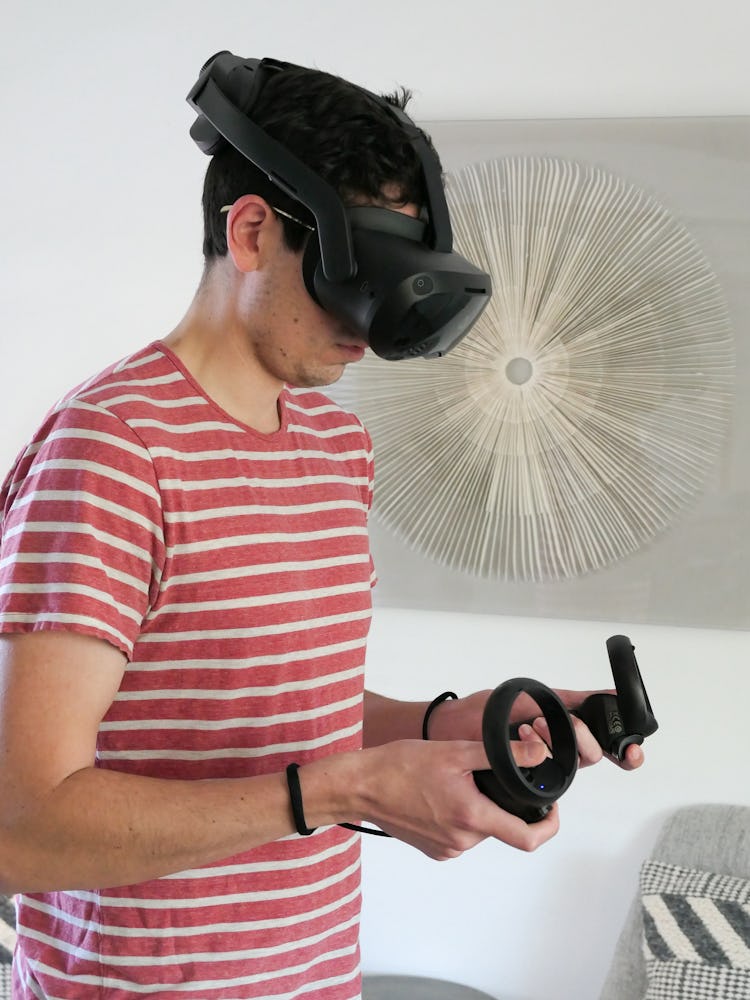 Wearing the Focus 3 and holding its controllers.