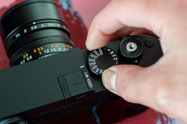 Adjusting the shutter speed dial of the M11. 