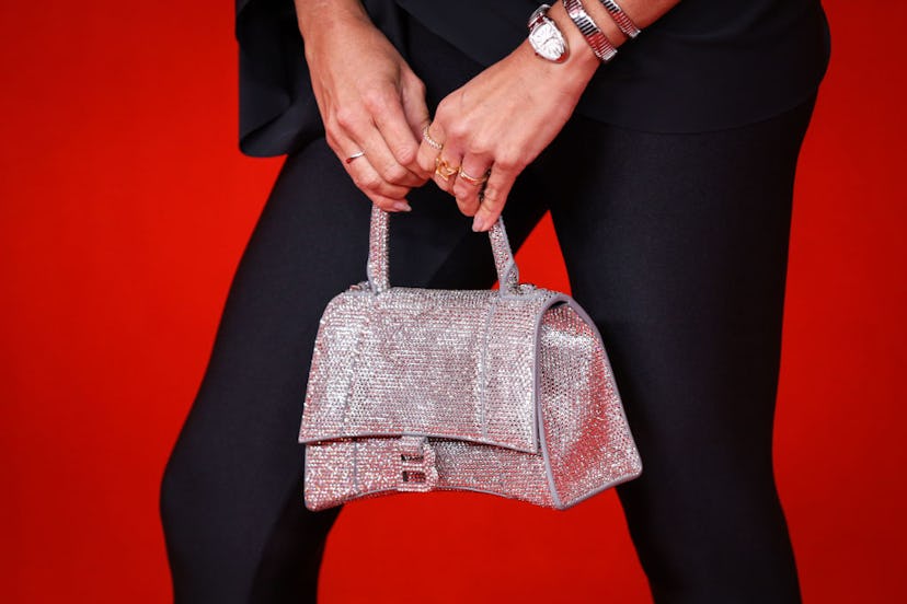 A woman holding a bag from Balenciaga Spring/Summer 2022 red carpet