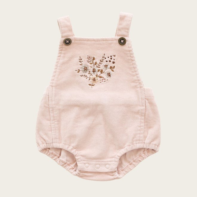 Flat lay of baby girl's overalls; pink with flowers