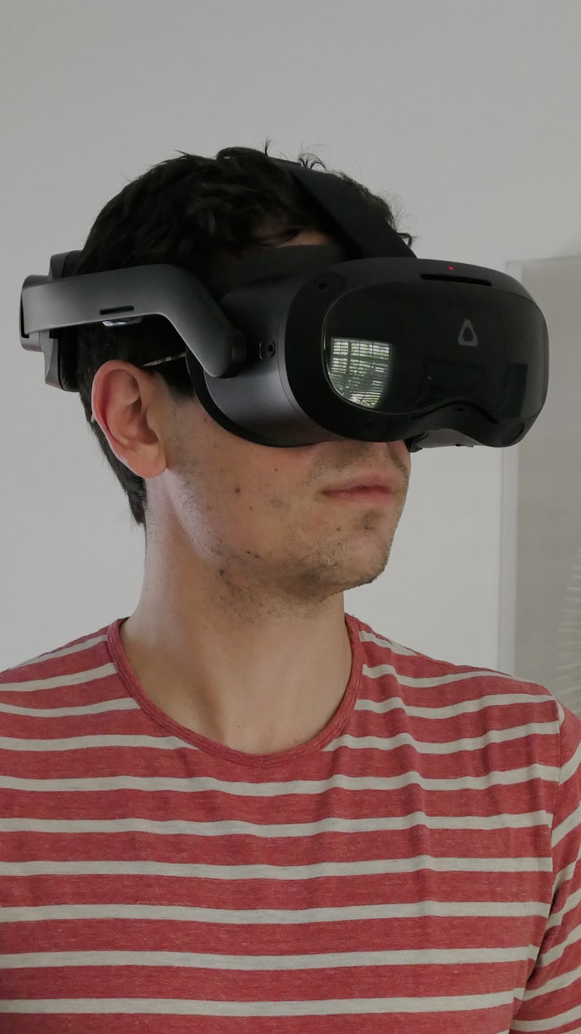 Wearing the Vive Focus 3 in front of a framed picture.