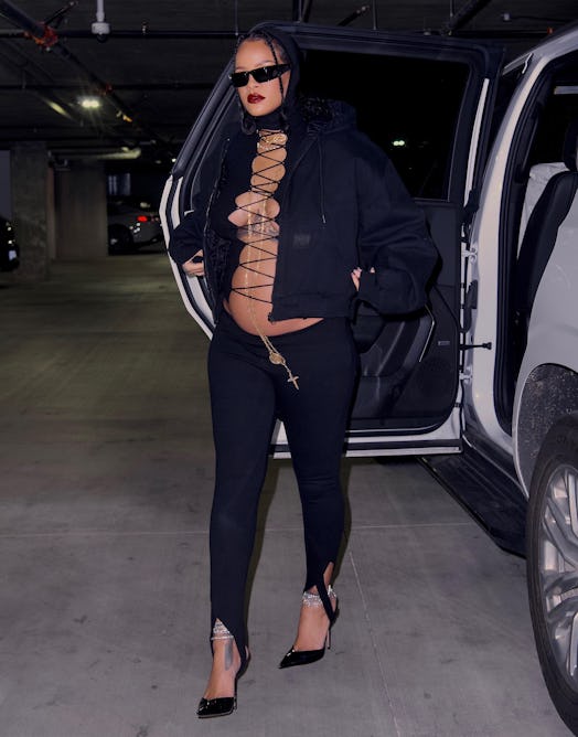 Rihanna wears The Attico black stirrup leggings.