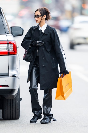 Bella Hadid carrying a Louis Vuitton shopping bag
