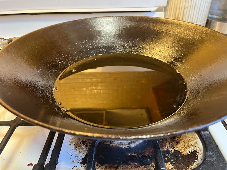 Lots of chicken grease in a wok.