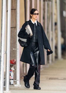 Bella Hadid carrying a manila envelope and notebook