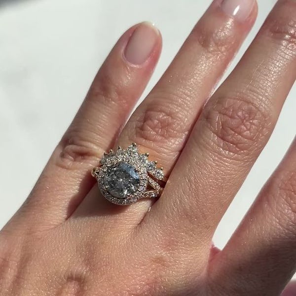 a salt and pepper engagement ring on a hand