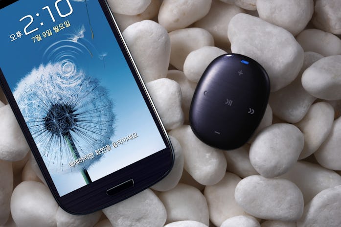 A Galaxy S3 and S Pebble sitting on a pile of rocks