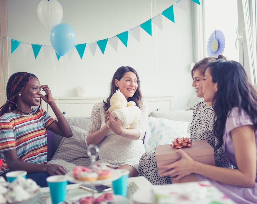 friends at a baby shower wearing different outfits