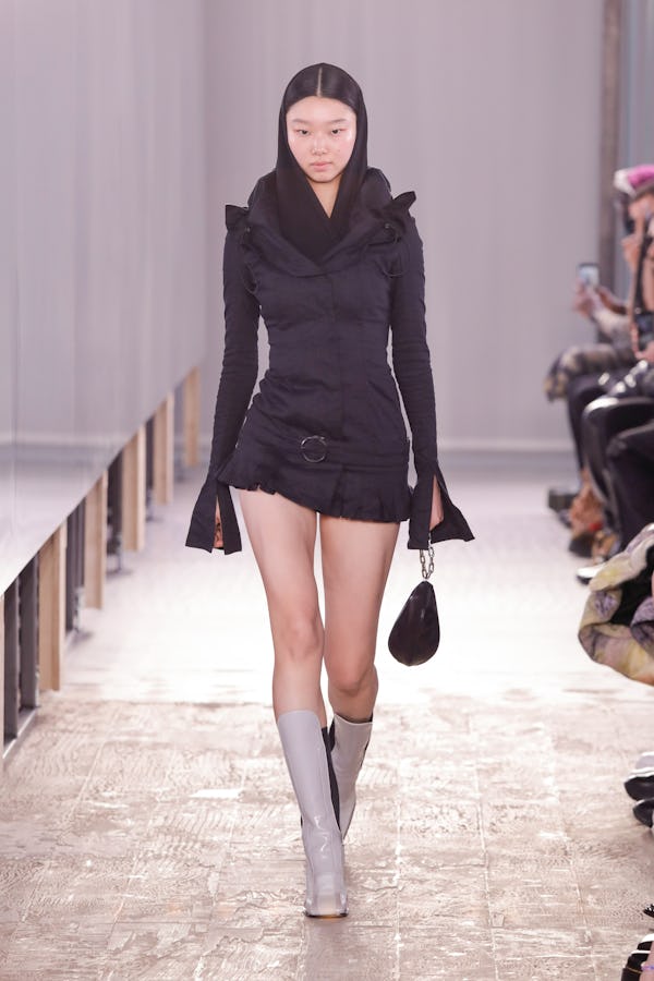 a model wearing a micro mini black skirt on the Trussardi runway