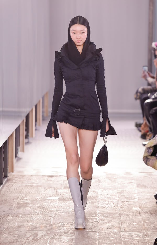 a model wearing a micro mini black skirt on the Trussardi runway