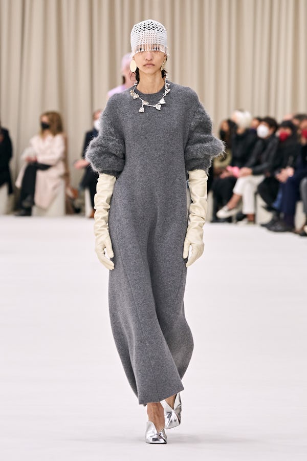 a model wearing a grey knit maxi dress on the Jil Sander runway