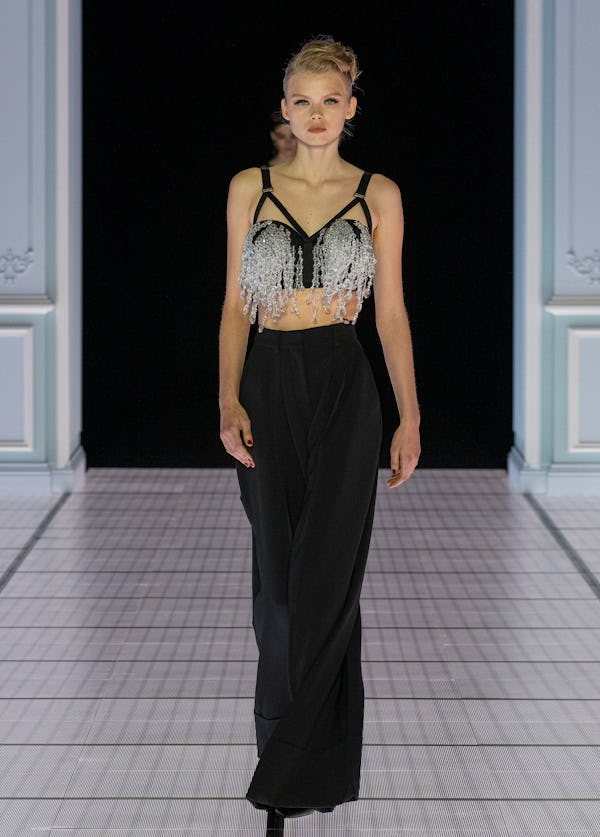 A model wearing a cutout crystal bra top on the Moschino runway