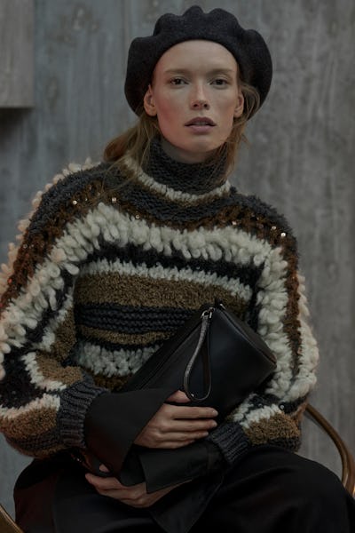 A model wearing a fringe knit sweater by Brunello Cucinelli