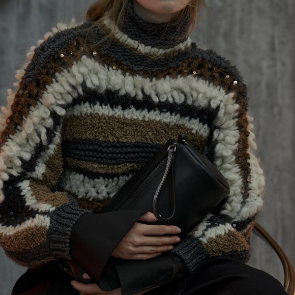 A model wearing a fringe knit sweater by Brunello Cucinelli