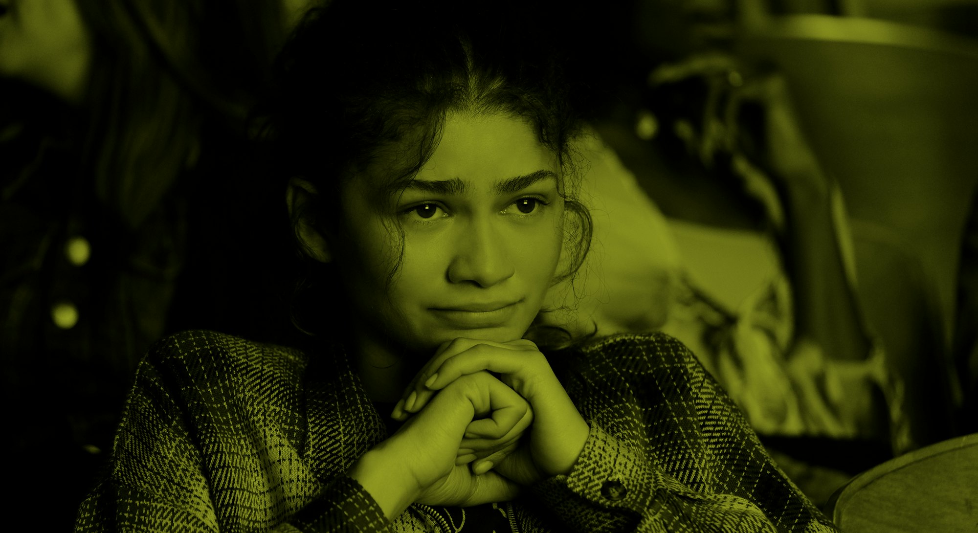 Zendaya, from "Euphoria", sitting down with hands under her chin, looking like she is close to tears...