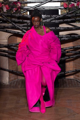 A model in a hot pink dress and coat walks the runway at Weinsanto Paris fashion week fall 2022