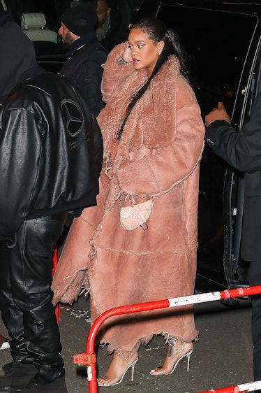 Rihanna leaving the fall 2022 Off-White show in a salmon-colored coat