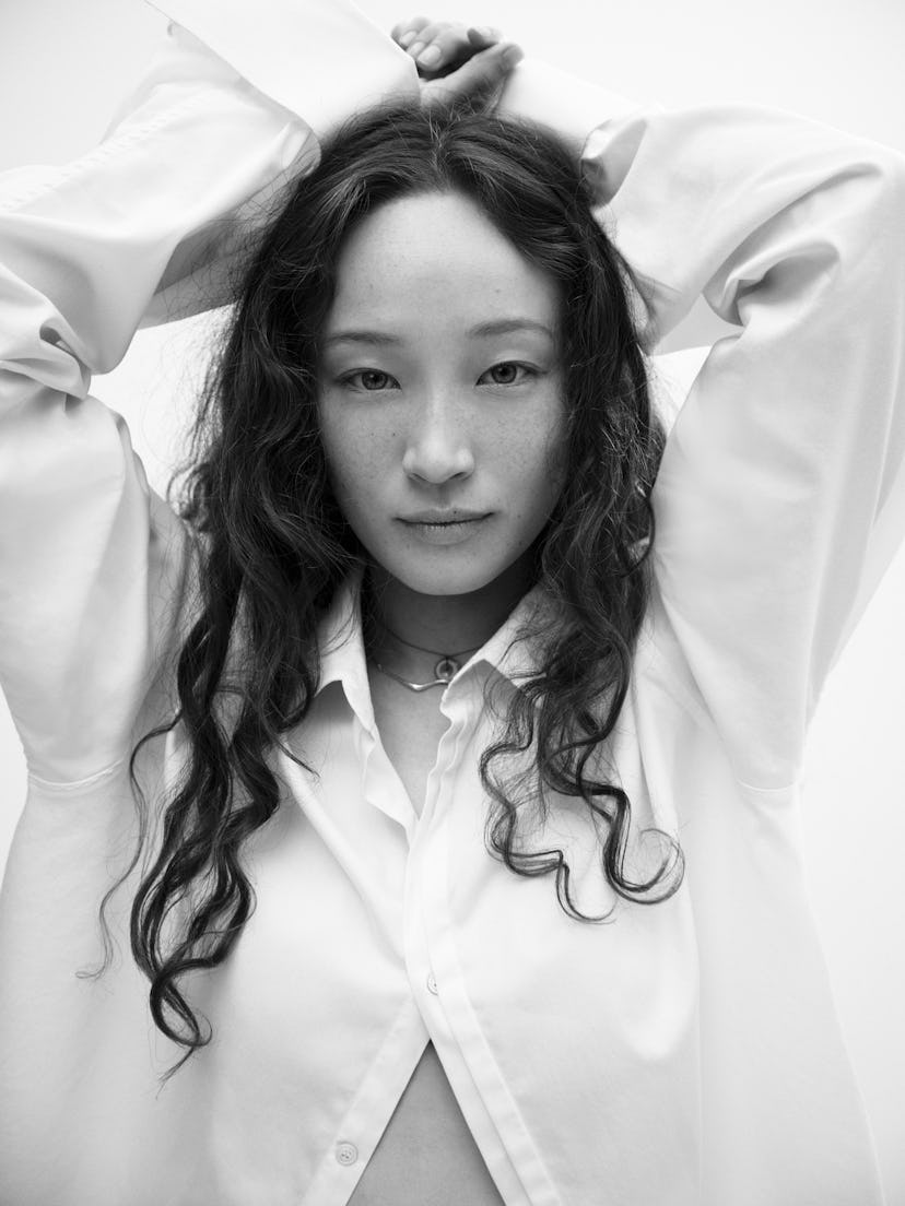 havana rose liu wearing white shirt and holding her hands above her head