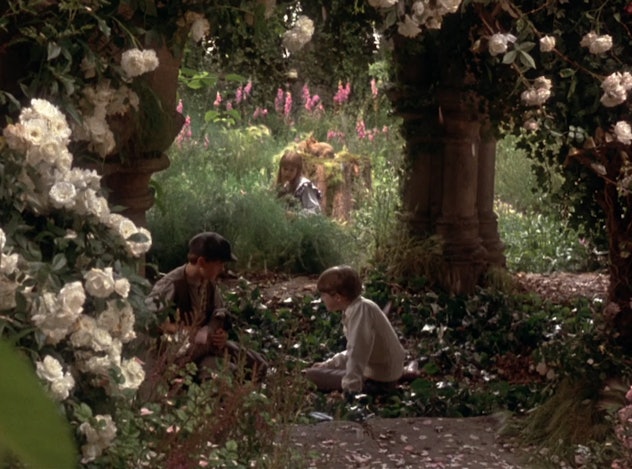 Dickon, Colin, and Mary sit in the secret garden
