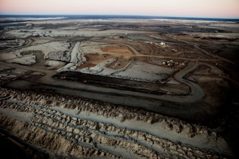 A view over dark tar sands to the horizon