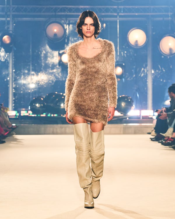 a model wearing a fuzzy beige mini dress on the Isabel Marant runway