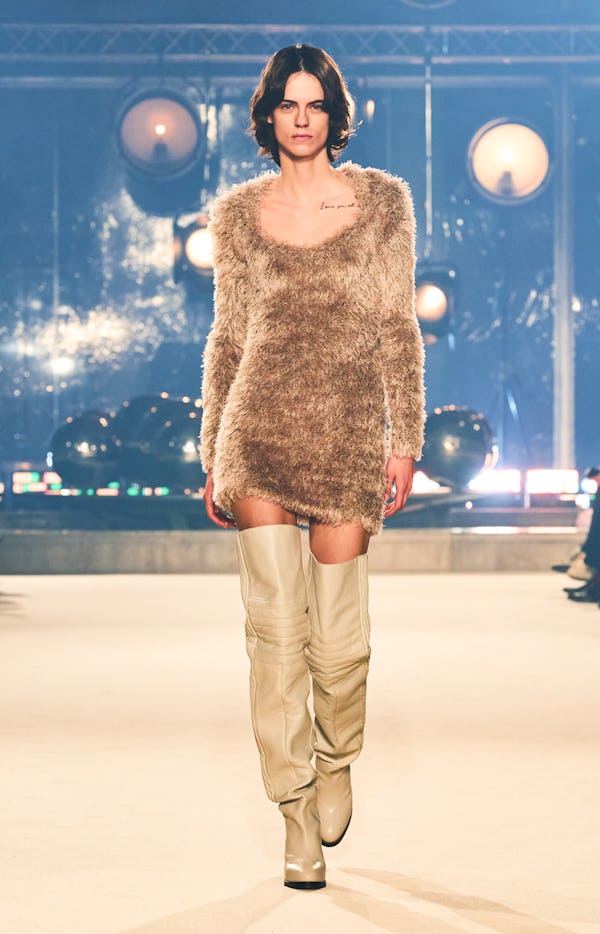 a model wearing a fuzzy beige mini dress on the Isabel Marant runway