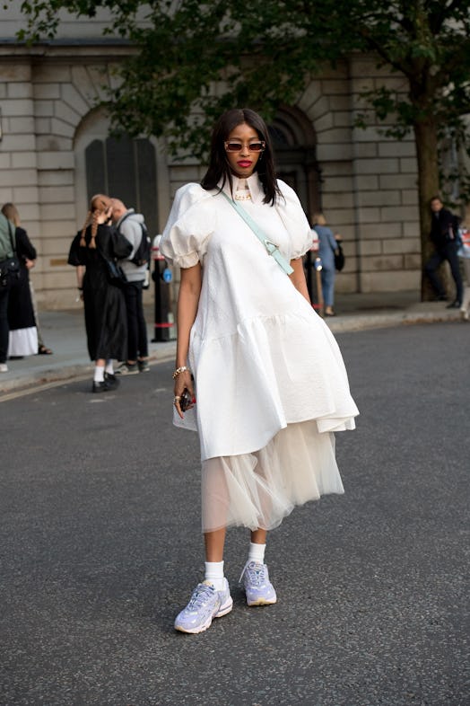 Rachael Broussard wears a What Rachael Wore dress and Nike trainers during London Fashion Week.