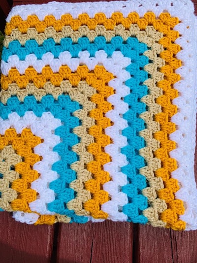 This baby blanket is stunning with it's teal, yellow, gold and white colors.