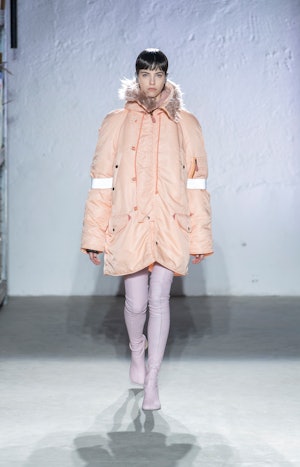 a model wearing pink leather second-skin boots on the MM6 Maison Margiela runway