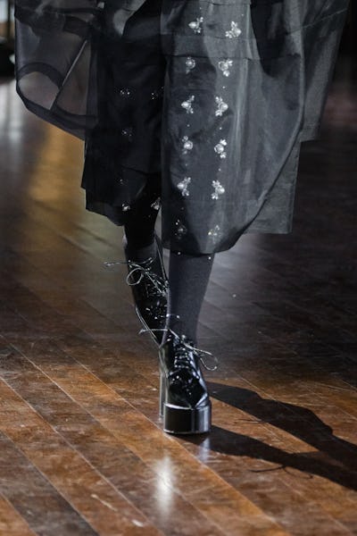 a model wearing black lace-up platform oxfords on the Simone Rocha runway