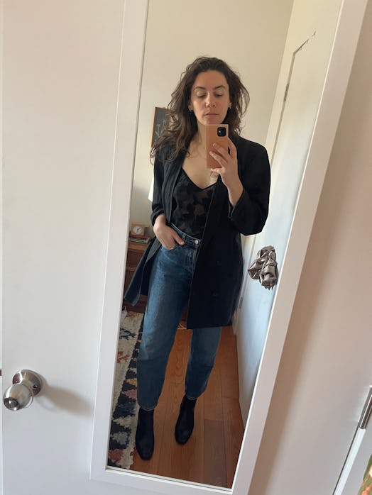 The writer wearing jeans and a black top