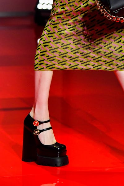a model wearing black patent leather platform mary jane heels on the Versace runway