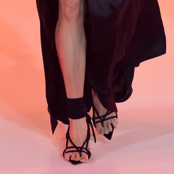a model wearing black strappy heeled strappy sandals on the Off-White runway