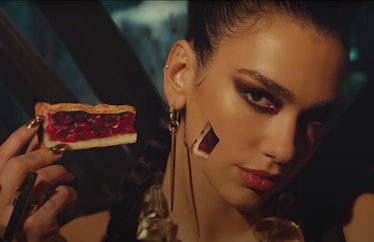 Dua Lipa taking a slice of pie out of her face in the Sweetest Pie video