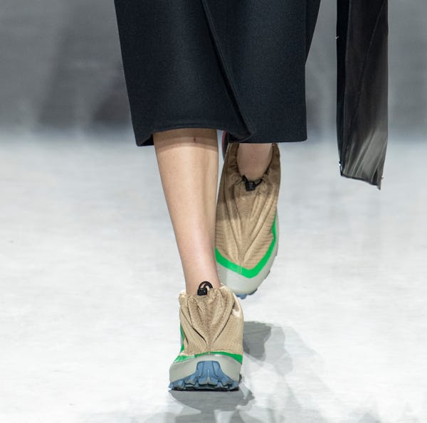 a model wearing sporty nylon sneakers on the MM6 Maison Margiela runway