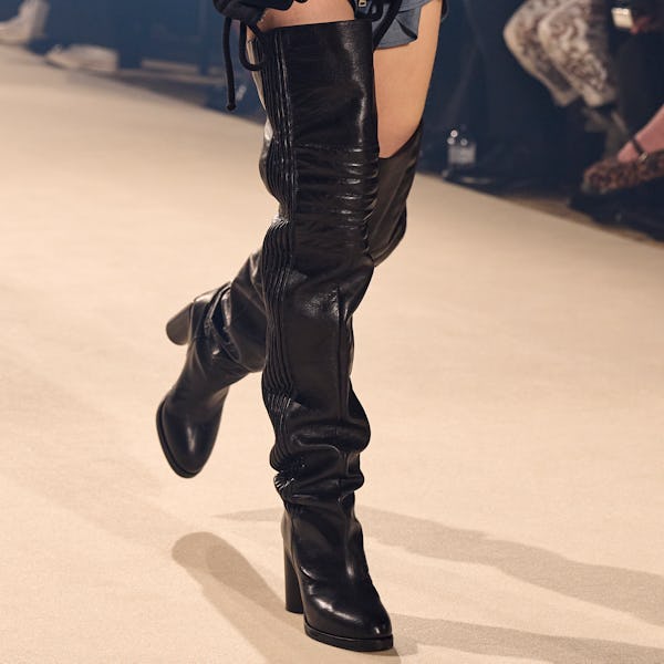 a model wearing black over-the-knee leather boots on the Isabel Marant runway