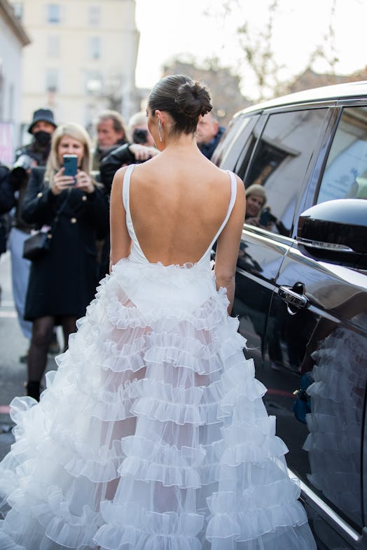 Olivia Culpo is seen wearing white body, sheer skirt outside Giambattista Valli.